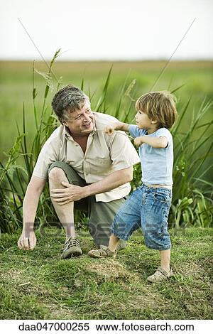 Little boy with grandfather outdoors View Large Photo Image Stock Photography - Little boy with grandfather outdoors. Fotosearch
