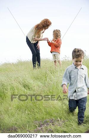 Little girl giving mother wildflowers View Large Photo Image Stock Photo - Little girl giving mother wildflowers. Fotosearch