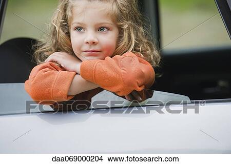 Little girl looking out car window, portrait View Large Photo Image Picture - Little girl looking out car window, portrait. Fotosearch