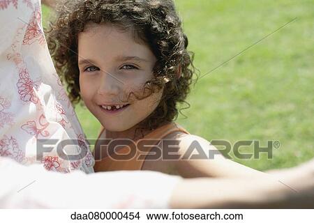 Picture - Little girl smiling outdoors. Fotosearch