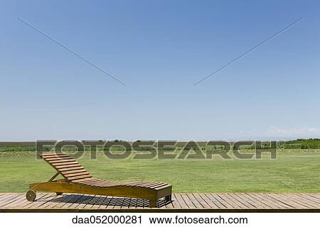 Lounge chair on deck in rural landscape View Large Photo Image Stock Image - Lounge chair on deck in rural landscape. Fotosearch