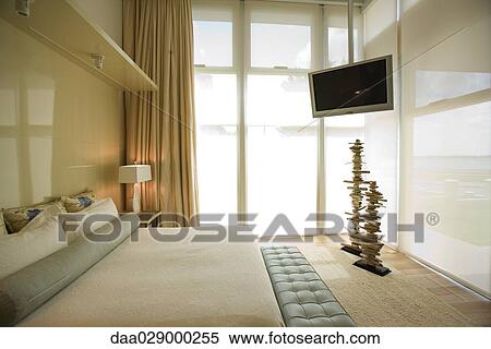 Luxury hotel room with large bed and widescreen television View Large Photo Image Stock Photography - Luxury hotel room with large bed and widescreen television. Fotosearch