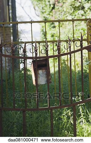 Mailbox hanging on wrought iron fence View Large Photo Image Stock Image - Mailbox hanging on wrought iron fence. Fotosearch