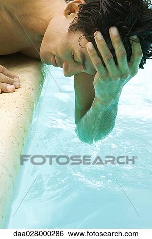 Man bending over swimming pool, wetting head with water, eyes closed, cropped view View Large Photo Image Stock Photograph - Man bending over swimming pool, wetting head with water, eyes closed, cropped view. Fotosearch