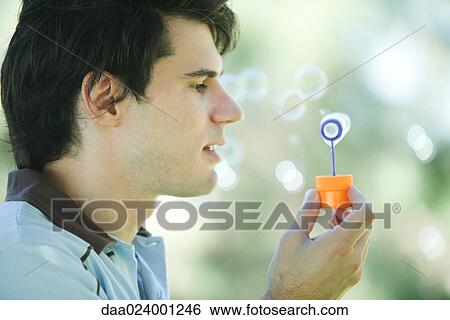 Man blowing bubbles View Large Photo Image Stock Photograph - Man blowing bubbles. Fotosearch