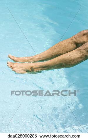 Man dipping feet in swimming pool, cropped view View Large Photo Image Stock Photography - Man dipping feet in swimming pool, cropped view. Fotosearch