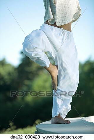 Stock Photo - Man doing yoga pose, chest down. Fotosearch
