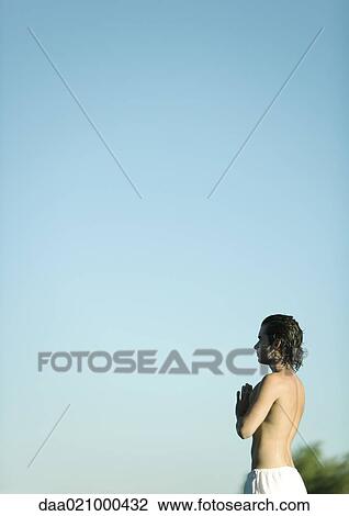 Man doing yoga pose outdoors, side view View Large Photo Image Stock Image - Man doing yoga pose outdoors, side view. Fotosearch