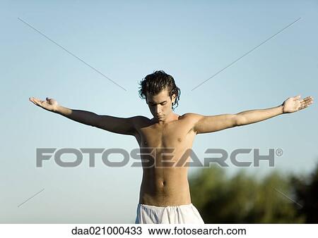 Stock Image - Man doing yoga pose outdoors. Fotosearch