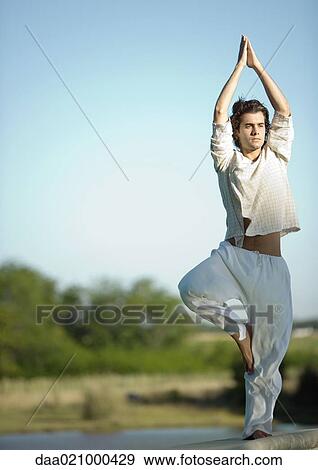 Man doing yoga pose outdoors View Large Photo Image Stock Photo - Man doing yoga pose outdoors. Fotosearch