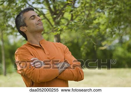 Stock Photography - Man enjoying fresh air outdoors. Fotosearch