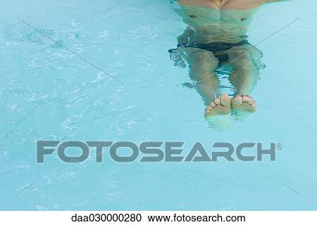 Man floating in swimming pool, cropped view View Large Photo Image Stock Image - Man floating in swimming pool, cropped view. Fotosearch