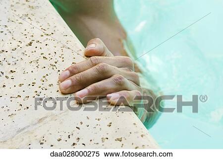 Man holding on to edge of swimming pool, cropped view of hand View Large Photo Image Stock Photography - Man holding on to edge of swimming pool, cropped view of hand. Fotosearch
