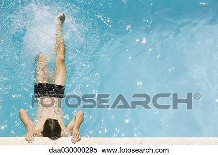 Man holding on to edge of swimming pool, kicking legs, high angle view View Large Photo Image Stock Photography - Man holding on to edge of swimming pool, kicking legs, high angle view. Fotosearch
