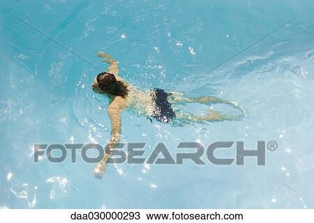 Man in swimming pool, arms out, high angle view View Large Photo Image Stock Image - Man in swimming pool, arms out, high angle view. Fotosearch