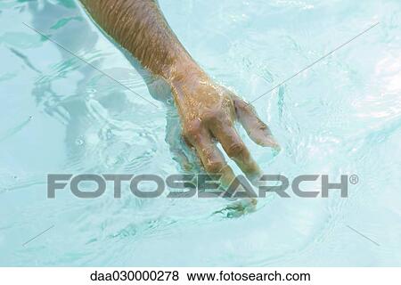 Man in swimming pool, cropped view of arm View Large Photo Image Stock Photo - Man in swimming pool, cropped view of arm. Fotosearch
