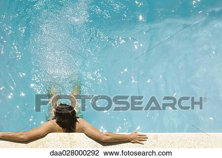 Man in swimming pool, holding on to edge, high angle view View Large Photo Image Stock Image - Man in swimming pool, holding on to edge, high angle view. Fotosearch