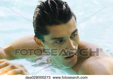 Man in swimming pool, looking over shoulder, close-up View Large Photo Image Stock Image - Man in swimming pool, looking over shoulder, close-up. Fotosearch