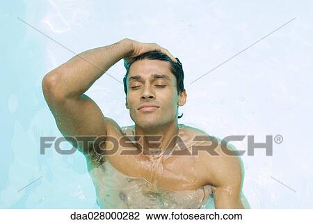 Man in swimming pool, pushing back hair, eyes closed View Large Photo Image Stock Image - Man in swimming pool, pushing back hair, eyes closed. Fotosearch