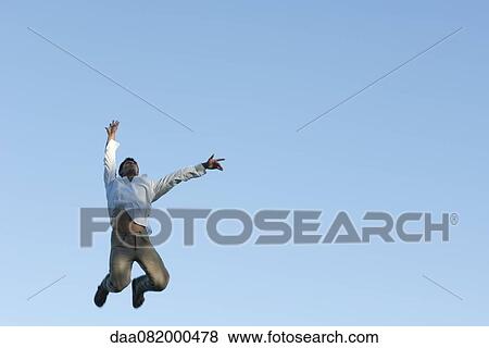 Stock Photo - Man jumping in air. Fotosearch