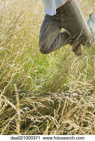 Man jumping in field, waist down View Large Photo Image Stock Image - Man jumping in field, waist down. Fotosearch