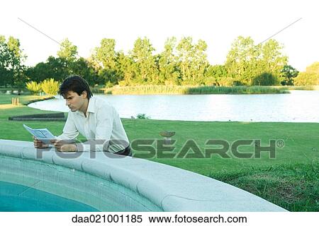 Man leaning on edge of pool, studying blueprints View Large Photo Image Stock Photography - Man leaning on edge of pool, studying blueprints. Fotosearch