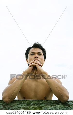 Man leaning on rail, hands clasped View Large Photo Image Stock Photo - Man leaning on rail, hands clasped. Fotosearch