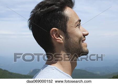 Stock Image - Man looking at scenic view, profile. Fotosearch