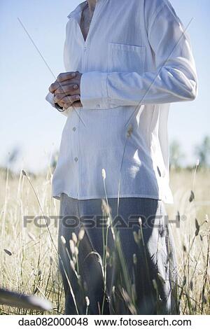 Man meditating in field, cropped View Large Photo Image Stock Photo - Man meditating in field, cropped. Fotosearch