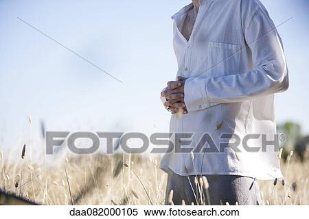 Man meditating in field, cropped View Large Photo Image Stock Photography - Man meditating in field, cropped. Fotosearch
