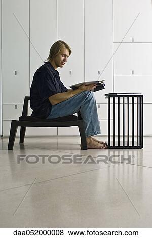 Stock Photo - Man reading magazine. Fotosearch