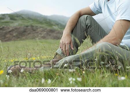 Man relaxing on meadow, cropped View Large Photo Image Stock Image - Man relaxing on meadow, cropped. Fotosearch