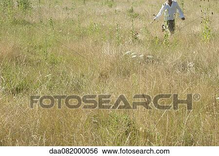 Man running through field, mid section View Large Photo Image Stock Photograph - Man running through field, mid section. Fotosearch