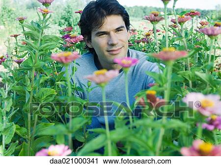 Man sitting in flowers View Large Photo Image Stock Image - Man sitting in flowers. Fotosearch