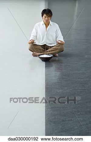 Man sitting in lotus position with bowl of incense View Large Photo Image Stock Image - Man sitting in lotus position with bowl of incense. Fotosearch