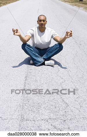 Man sitting in middle of the road in lotus position View Large Photo Image Stock Photo - Man sitting in middle of the road in lotus position. Fotosearch