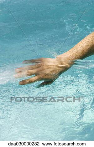 Man splashing in pool, cropped view of hand View Large Photo Image Stock Image - Man splashing in pool, cropped view of hand. Fotosearch