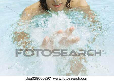 Man splashing in swimming pool, cropped view View Large Photo Image Stock Photo - Man splashing in swimming pool, cropped view. Fotosearch