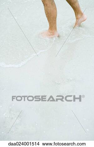 Man standing in surf, knee down View Large Photo Image Picture - Man standing in surf, knee down. Fotosearch