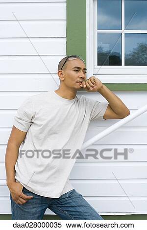 Man standing, leaning on railing next to house, hand under chin View Large Photo Image Stock Photography - Man standing, leaning on railing next to house, hand under chin. Fotosearch