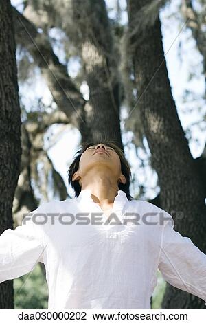 Man standing outdoors with head back, eyes closed View Large Photo Image Stock Image - Man standing outdoors with head back, eyes closed. Fotosearch