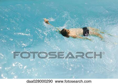 Man swimming backstroke in pool, high angle view View Large Photo Image Stock Image - Man swimming backstroke in pool, high angle view. Fotosearch