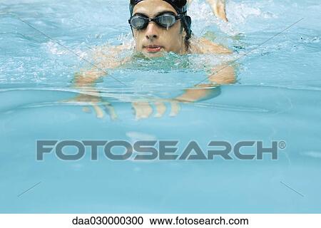 Man swimming in pool, wearing goggles View Large Photo Image Stock Image - Man swimming in pool, wearing goggles. Fotosearch