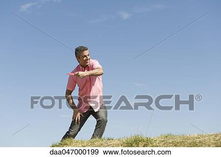 Man throwing flying disc View Large Photo Image Stock Photo - Man throwing flying disc. Fotosearch
