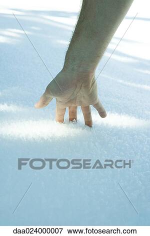 Man's hand touching snow View Large Photo Image Stock Photo - Man's hand touching snow. Fotosearch