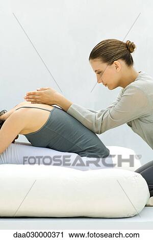 Massage therapist giving woman a back massage View Large Photo Image Stock Image - Massage therapist giving woman a back massage. Fotosearch
