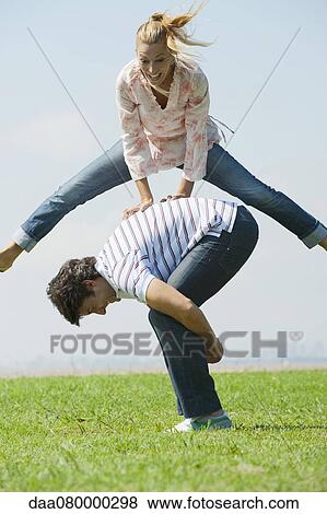 Mature couple playing leapfrog View Large Photo Image Stock Photo - Mature couple playing leapfrog. Fotosearch
