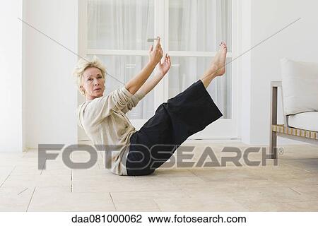 Mature woman doing boat pose View Large Photo Image Stock Image - Mature woman doing boat pose. Fotosearch