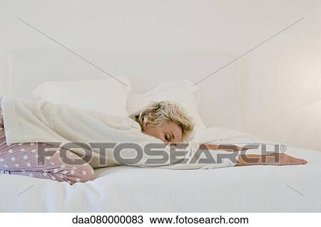 Mature woman doing child's pose on bed View Large Photo Image Stock Image - Mature woman doing child's pose on bed. Fotosearch
