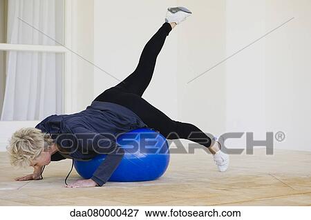 Mature woman doing pilates exercise on fitness ball View Large Photo Image Stock Photo - Mature woman doing pilates exercise on fitness ball. Fotosearch